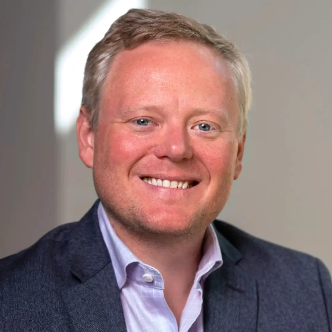 Headshot of Phil Hudgens, Fund Controller at Chang Robotics Fund, smiling in a blazer and collared shirt.